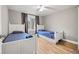 Charming bedroom featuring two twin beds, gray walls, light wood floors and natural light at 3908 Alafia Blvd, Brandon, FL 33511