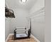 A closet with a pack and play, hanging clothes, and wood-look floors at 3908 Alafia Blvd, Brandon, FL 33511