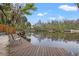Enjoy tranquil water views from the private wooden dock, perfect for relaxing and enjoying nature's beauty at 3908 Alafia Blvd, Brandon, FL 33511