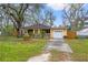 Inviting single-Gathering home with a neatly kept lawn, a driveway, and mature trees at 3908 Alafia Blvd, Brandon, FL 33511