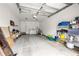 Spacious garage with overhead lighting, utility sink, washer, dryer, and ample storage shelving at 3908 Alafia Blvd, Brandon, FL 33511