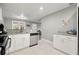 Well-lit kitchen area with white cabinets and granite countertops at 3908 Alafia Blvd, Brandon, FL 33511