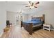 Spacious bedroom with light wood floors, ceiling fans and access to the backyard through a set of french doors at 3908 Alafia Blvd, Brandon, FL 33511