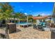 Landscaped backyard featuring a pool, patio, shade, and ample seating for entertaining at 4135 Beach Se Dr, St Petersburg, FL 33705