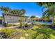 A serene backyard featuring lush greenery, a sparkling pool, and beautiful landscaping at 4135 Beach Se Dr, St Petersburg, FL 33705