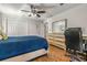 The bedroom features wood floors, a ceiling fan, and a spacious closet for storage at 4135 Beach Se Dr, St Petersburg, FL 33705