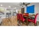 Open-concept dining area with red leather chairs, wooden table, barn door, and modern lighting fixtures at 4135 Beach Se Dr, St Petersburg, FL 33705