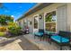 Inviting front porch with seating, decorative lighthouse, and charming details on a well-maintained gray brick home at 4135 Beach Se Dr, St Petersburg, FL 33705