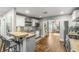 Modern kitchen with white cabinets, stainless steel appliances, breakfast bar, and open view to the living space at 4135 Beach Se Dr, St Petersburg, FL 33705