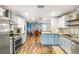 The charming kitchen boasts stainless appliances, light blue cabinets, and a cozy dining area at 4135 Beach Se Dr, St Petersburg, FL 33705