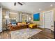 A cozy living room features a comfortable brown leather sofa, decorative pillows, and natural light at 4135 Beach Se Dr, St Petersburg, FL 33705