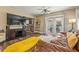 A comfortable living room features a brown leather sofa, a television, and backyard access at 4135 Beach Se Dr, St Petersburg, FL 33705