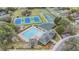 Aerial view of community pool, clubhouse, tennis courts, and playground amenities at 5088 Championship Cup Ln, Spring Hill, FL 34609