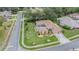 Stunning aerial view of a well-maintained home with a screened-in pool and lush green landscaping in a desirable neighborhood at 5088 Championship Cup Ln, Spring Hill, FL 34609