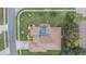 Aerial view of the property showcasing the screened pool and lush landscaping of the home at 5088 Championship Cup Ln, Spring Hill, FL 34609