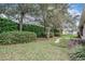 Secluded backyard retreat with lush greenery, mature trees, and privacy hedges creating a serene outdoor space at 5088 Championship Cup Ln, Spring Hill, FL 34609