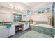 Bright bathroom featuring double sinks, soaking tub, tiled accents, and ample natural light at 5088 Championship Cup Ln, Spring Hill, FL 34609