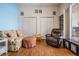 Cozy bedroom with comfortable seating, floral accents, and two closets at 5088 Championship Cup Ln, Spring Hill, FL 34609
