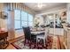 Elegant dining room with large window, round table, decorative rug, and built in display cabinets at 5088 Championship Cup Ln, Spring Hill, FL 34609