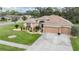 Inviting single-Gathering home boasts a well-manicured lawn, landscaping, and a two-car garage with ample driveway space at 5088 Championship Cup Ln, Spring Hill, FL 34609