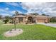 Charming single-story home with a well-manicured lawn, mature landscaping, and an attached three-car garage at 5088 Championship Cup Ln, Spring Hill, FL 34609