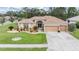 Welcoming single-Gathering home with a beautifully landscaped front yard and a spacious two-car garage at 5088 Championship Cup Ln, Spring Hill, FL 34609