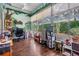 Inviting Florida room with floor-to-ceiling windows, mural and views of the outdoors at 5088 Championship Cup Ln, Spring Hill, FL 34609