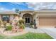 Inviting front entrance with decorative door, charming landscaping, and a cozy bench at 5088 Championship Cup Ln, Spring Hill, FL 34609