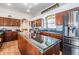 Modern kitchen with wooden cabinets, stainless steel appliances, and a large center island at 5088 Championship Cup Ln, Spring Hill, FL 34609