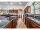 Large kitchen with wooden cabinets, tile floors, and long granite countertops at 5088 Championship Cup Ln, Spring Hill, FL 34609