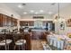 Well-lit kitchen featuring wooden cabinets, stainless steel appliances, and a dining area at 5088 Championship Cup Ln, Spring Hill, FL 34609