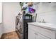 Bright laundry room with washer, dryer, utility sink, and ample storage at 5088 Championship Cup Ln, Spring Hill, FL 34609