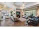 Bright living room featuring tile floors, large windows, and comfortable seating areas at 5088 Championship Cup Ln, Spring Hill, FL 34609