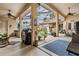 Spacious outdoor patio with ceiling fans, comfortable seating, and access to a screened-in pool area at 5088 Championship Cup Ln, Spring Hill, FL 34609