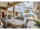 Outdoor dining on the spacious patio overlooking the screened-in pool area, ideal for entertaining at 5088 Championship Cup Ln, Spring Hill, FL 34609
