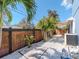 Landscaped backyard showcasing a modern fence and lush tropical plants at 5526 14Th S Ave, Gulfport, FL 33707