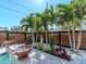 Zen backyard with outdoor planters, palm trees, and travertine tile at 5526 14Th S Ave, Gulfport, FL 33707