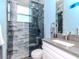 Modern bathroom with walk-in glass shower, elegant vanity with white cabinets, and designer fixtures at 5526 14Th S Ave, Gulfport, FL 33707