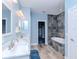 Modern bathroom featuring a double vanity, a tiled shower, and a soaking tub at 5526 14Th S Ave, Gulfport, FL 33707