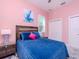 Charming bedroom featuring a cozy blue quilt, stylish headboard, and natural light from the window at 5526 14Th S Ave, Gulfport, FL 33707