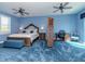 Spacious blue themed bedroom with screen, desk and a decorative chair at 5526 14Th S Ave, Gulfport, FL 33707