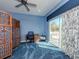 Well-lit bedroom featuring a desk, seating area, and a sliding glass door leading to a balcony at 5526 14Th S Ave, Gulfport, FL 33707