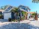 Beautiful blue two-story home with white trim, landscaped yard, and a paved driveway to the garage at 5526 14Th S Ave, Gulfport, FL 33707