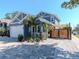 Charming blue two-story home with meticulously landscaped garden and a paved driveway leading to the garage at 5526 14Th S Ave, Gulfport, FL 33707