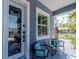 Welcoming front porch with stylish seating, a decorative window, and a beautiful stained-glass door at 5526 14Th S Ave, Gulfport, FL 33707