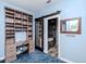 Home office with custom built-in shelving and a peek at the bathroom at 5526 14Th S Ave, Gulfport, FL 33707