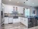 Bright kitchen with white cabinets, stainless steel appliances, black marbled island, and modern fixtures at 5526 14Th S Ave, Gulfport, FL 33707