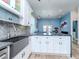 Kitchen island with white cabinets, granite countertops, and a sleek black sink at 5526 14Th S Ave, Gulfport, FL 33707