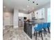 Modern kitchen featuring stainless steel appliances, an island with stone slab, pendant lighting, and seating at 5526 14Th S Ave, Gulfport, FL 33707