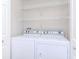 Laundry room with a modern side-by-side washer and dryer and wire shelving at 5526 14Th S Ave, Gulfport, FL 33707